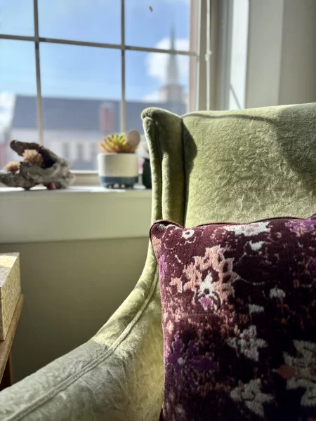 Image of a purple pillow on a green chair from one of our therapy rooms.