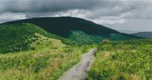 Image of mountains with a trail winding through.